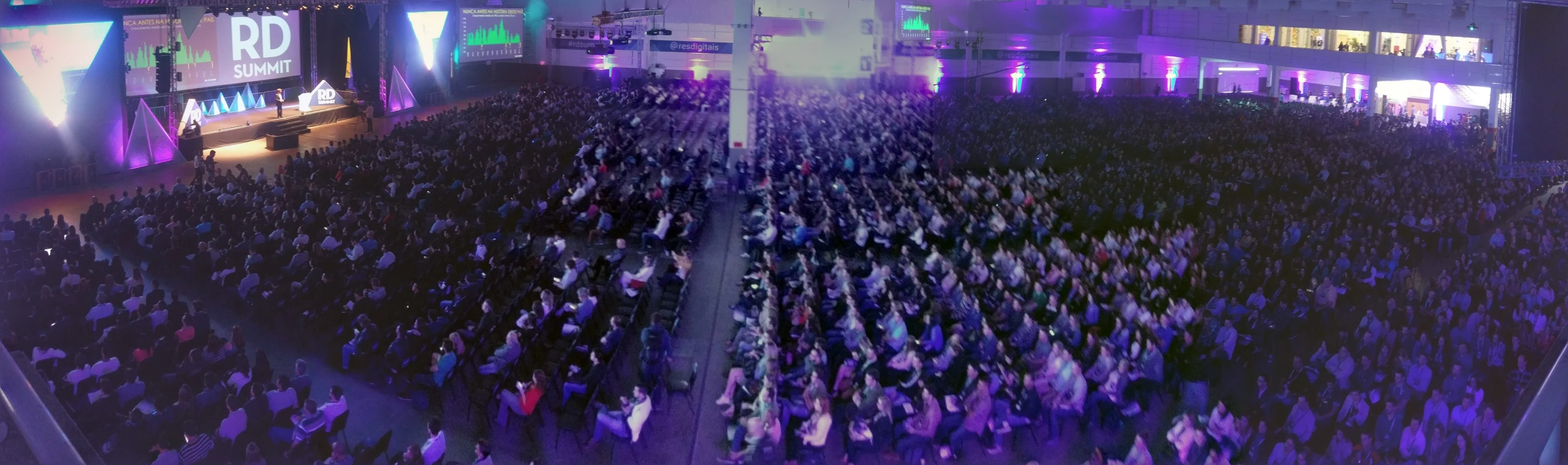 Wide view of the packed RD Summit auditorium and illuminated stage